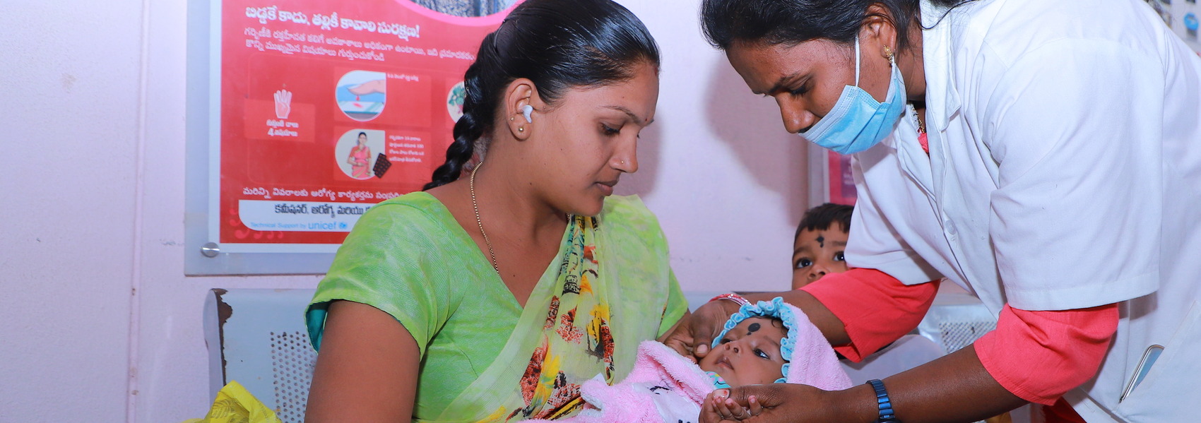 Woman and doctor holding a baby